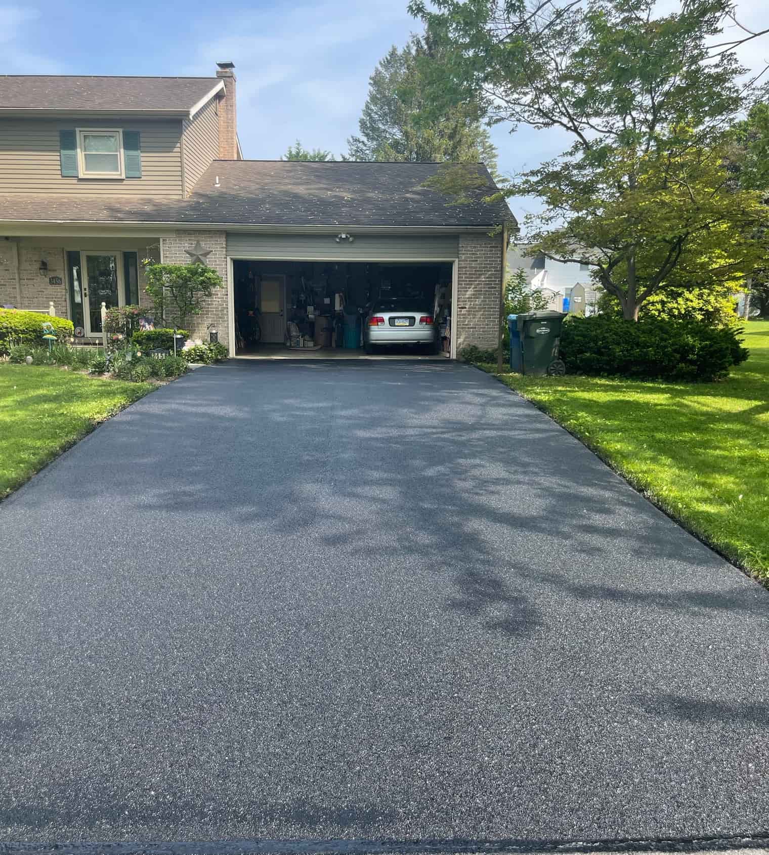 Finished driveway paving leading to a home garage