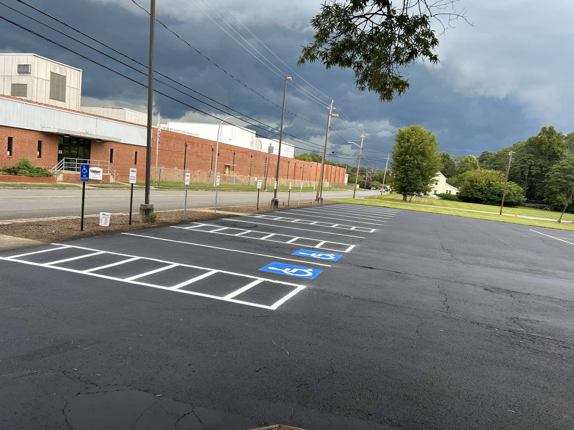Freshly paved and striped parking lot with ADA spaces